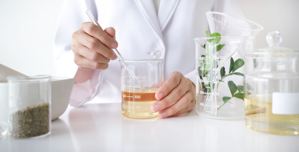 Research & development measuring and mixing all natural ingredients for skincare products.